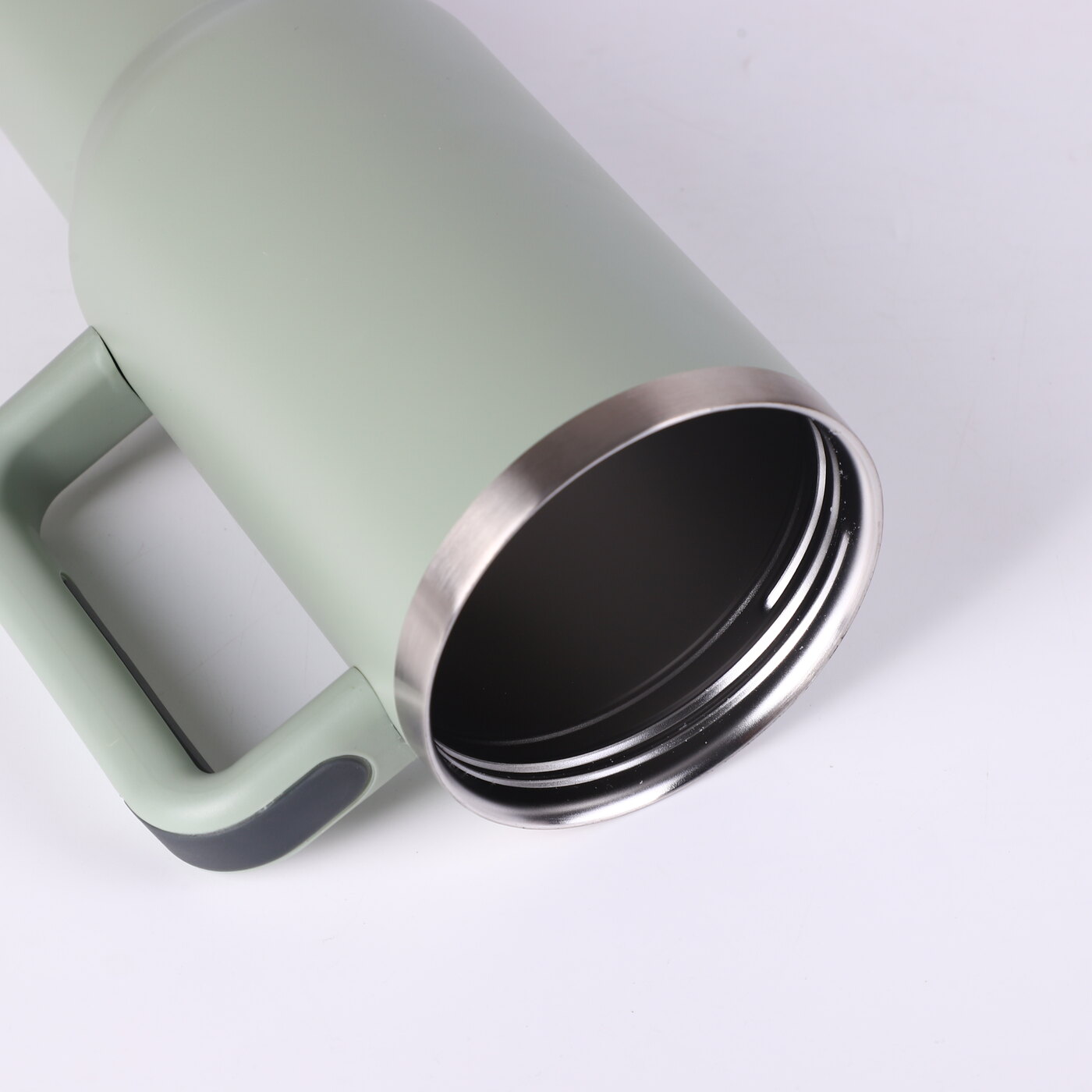 Close view of the Insulated Tumbler's stainless steel rim and vacuum-insulated wall